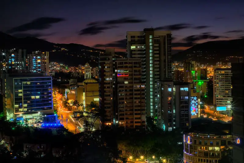 Night view of El Poblado, Medellin, highlighting the vibrant skyline and city lights, perfect for exploring Where to Stay in Medellin.