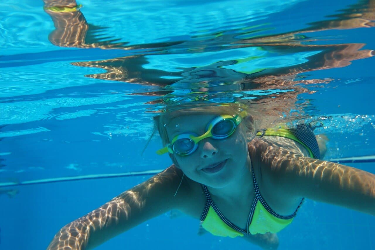 Girl snorkeling in the crystal-clear waters of Bali, an exciting activity in the 10-Day Bali Itinerary for Family.