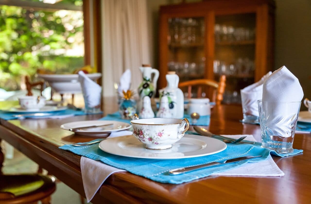 Fine dining table setup with elegant plates, glasses, and cutlery, showcasing a luxurious dining experience in Tallinn