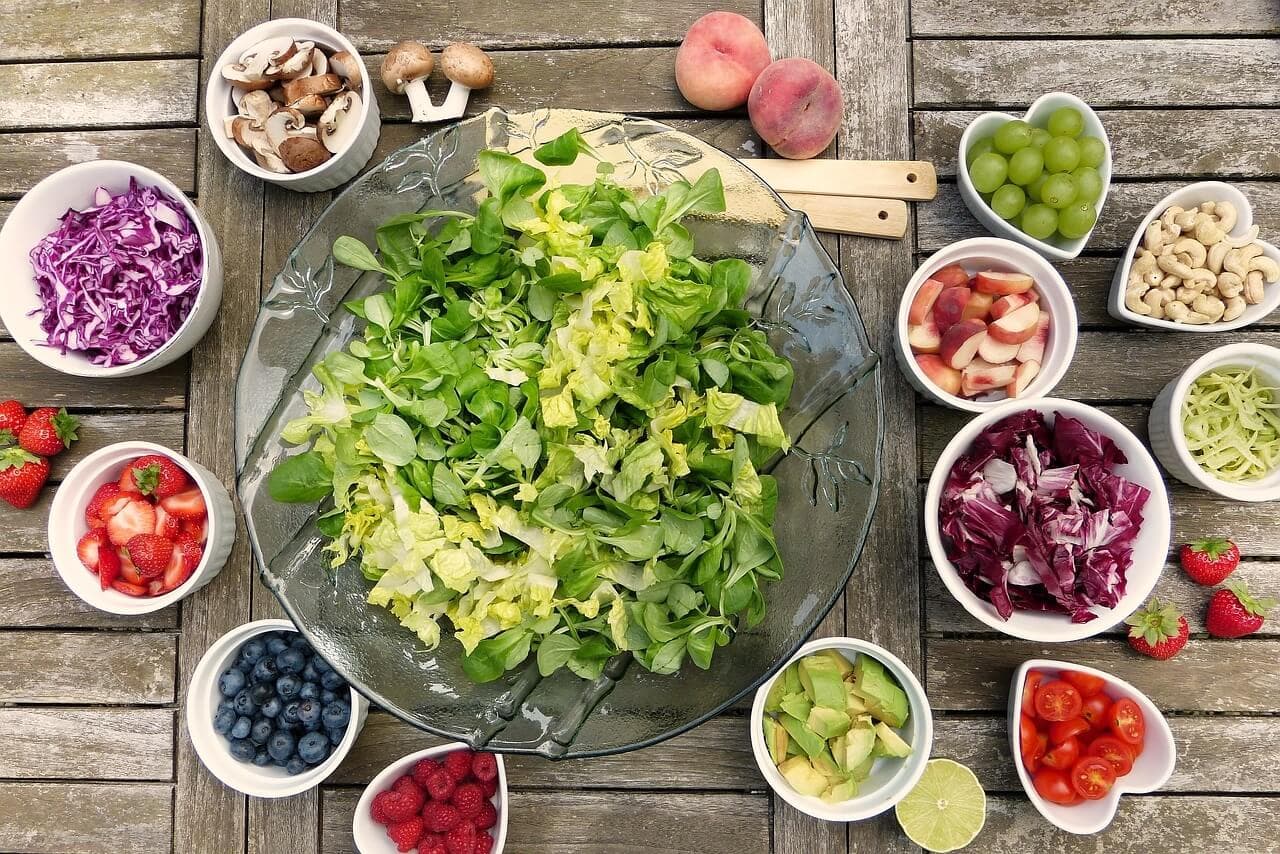 Vegan platter with a variety of fresh salad, fruit, and berries